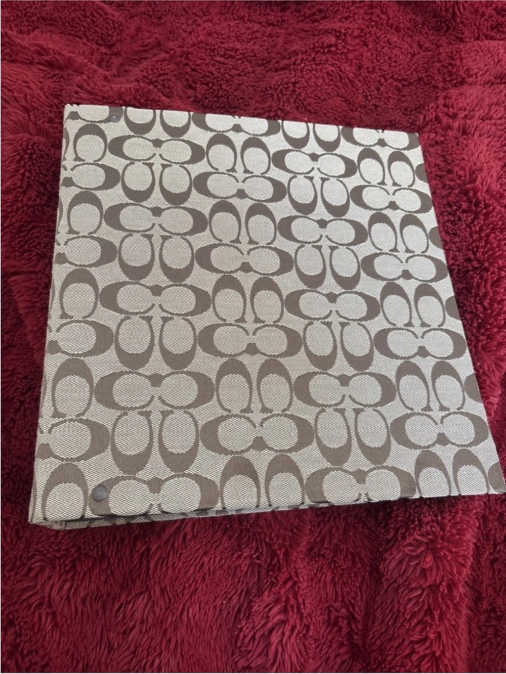 COACH Signature canvas binder featuring the brand's iconic "C" monogram print.